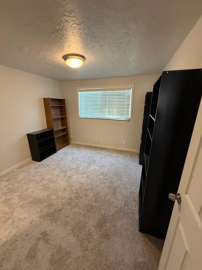 Open floor space after a Columbia Junk Removal room cleanout, with shelving still in the room